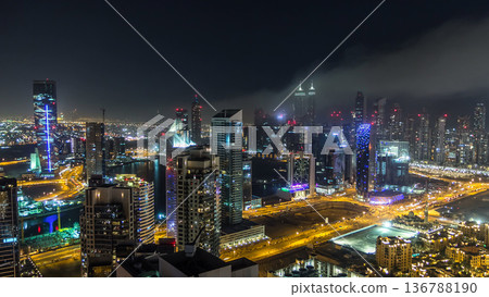 Aerial view of a big modern city at night timelapse. Business bay, Dubai, United Arab Emirates. Aerial view of a big modern city at night timelapse. Business bay, Dubai, United Arab Emirates. 136788190