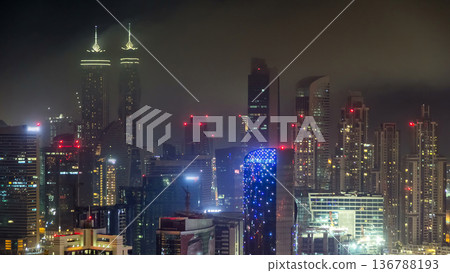 Aerial view of a big modern city at night timelapse. Business bay, Dubai, United Arab Emirates. 136788193