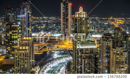 Top view of road in Dubai downtown timelapse with night traffic and illuminated skyscrapers. Top view of road in Dubai downtown timelapse with night traffic and illuminated skyscrapers. 136788200