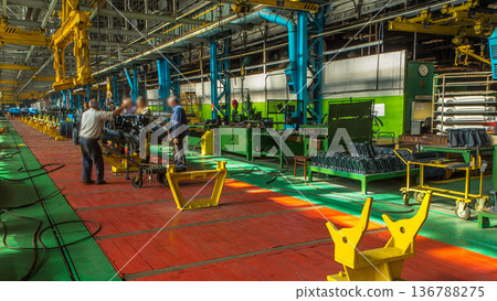 Conveyor assembly stage the body of tractor at big industrial factory timelapse Conveyor assembly stage the body of tractor at big industrial factory timelapse 136788275