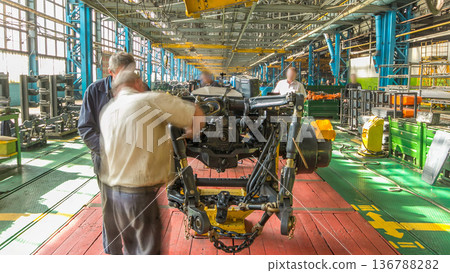 Conveyor assembly stage the body of tractor at big industrial factory timelapse 136788282