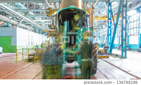 Conveyor assembly stage the body of tractor at big industrial factory timelapse 136788286