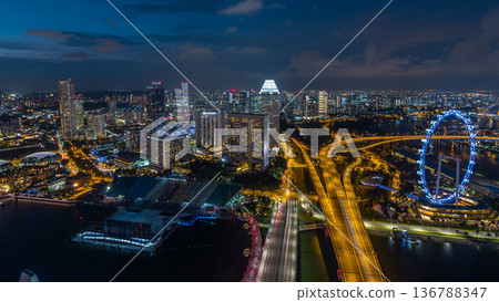 Skyline of Singapore with famous Singapore Ferries Wheel day to night timelapse at twilight Skyline of Singapore with famous Singapore Ferries Wheel day to night timelapse at twilight 136788347