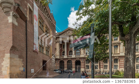 Renaissance dungeon clock tower and classical brick facade of the Capitole timelapse hyperlapse, city hall of Toulouse, France 136788365