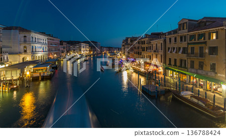 Grand Canal in Venice, Italy day to night timelapse. Gondolas and city lights from Rialto Bridge. 136788424