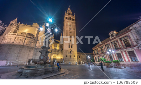 La Giralda and Seville Cathedral timelapse hyperlapse glowing under the night sky. 136788509