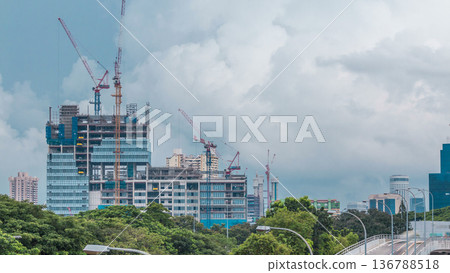 Construction site of a modern skyscraper in Singapore timelapse Construction site of a modern skyscraper in Singapore timelapse 136788518