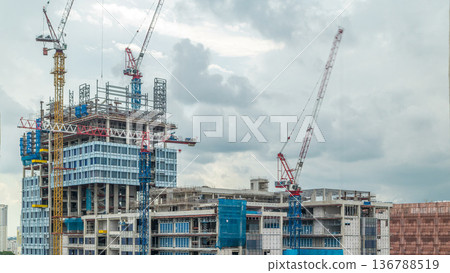 Construction site of a modern skyscraper in Singapore timelapse Construction site of a modern skyscraper in Singapore timelapse 136788519