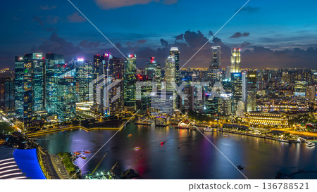 Aerial view of Singapore business district skyscrapers at evening with water reflections day to night timelapse Aerial view of Singapore business district skyscrapers at evening with water reflections day to night timelapse 136788521