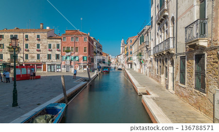 A view of Venice timelapse: canal, bridge, boats and an old tower in the background A view of Venice timelapse: canal, bridge, boats and an old tower in the background 136788571