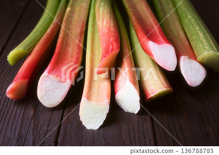 Cut rhubarb stalks arranged on wooden table Cut rhubarb stalks arranged on wooden table 136788785
