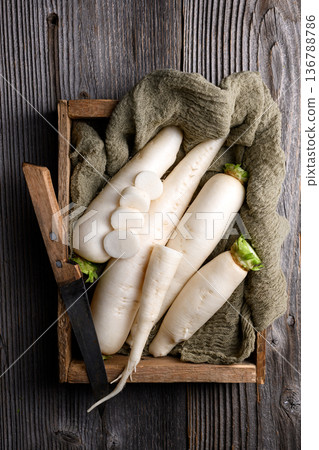 Daikon radish arranged on fabric and wood 136788786