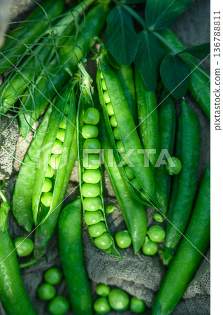 Fresh green peas on textile background 136788811