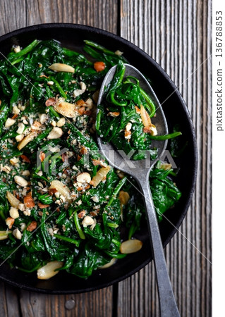 Overhead food photography of cooked spinach with roasted garlic 136788853