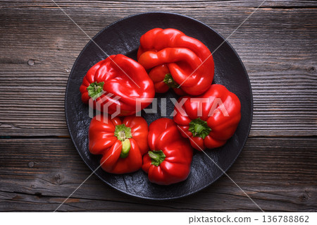 Red bell peppers arranged in black plate 136788862