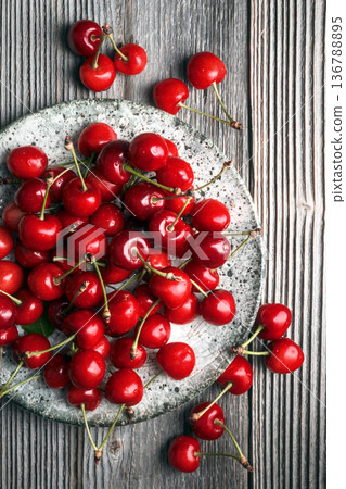 Top view of ripe cherries scattered on wooden background Top view of ripe cherries scattered on wooden background 136788895