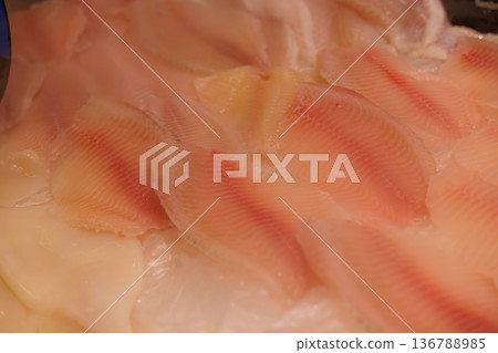 Delicate slices of fish ready for a culinary creation in a cozy kitchen setting Delicate slices of fish ready for a culinary creation in a cozy kitchen setting 136788985