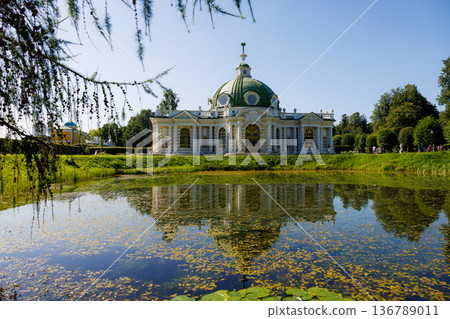 Beautiful summer day at the historic pavilion beside the tranquil pond in a lush garden setting Beautiful summer day at the historic pavilion beside the tranquil pond in a lush garden setting 136789011