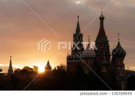Sunset over St. Basil's Cathedral with vibrant colors and silhouette of Moscow skyline 136789049