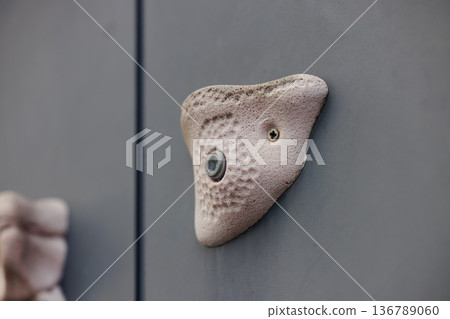 Climbing hold mounted on wall for indoor training and bouldering Climbing hold mounted on wall for indoor training and bouldering 136789060