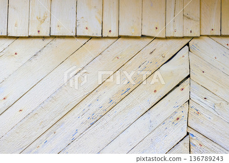 Weathered white yellow wooden wall with peeling paint 136789243