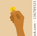 A gold coin in a man's hand 136789325