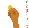 A gold coin in a man's hand 136789326
