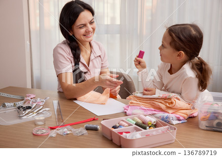 Mother and little daughter bonding, learning craft skills, and creating handmade items 136789719