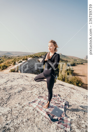 Yoga on the Mountain Top: Woman in Tree Pose with Laptop Yoga on the Mountain Top: Woman in Tree Pose with Laptop 136789739