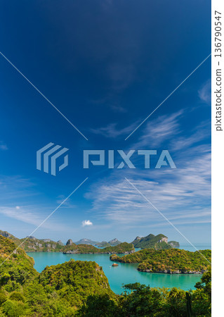 Tropical seascape of Mu Ko Ang Thong Marine Park islands in Thailand with emerald water, limestone formations and clear blue sky, panoramic view of famous national marine park near Ao Nang Tropical seascape of Mu Ko Ang Thong Marine Park islands in Thailand with emerald water, limestone formations and clear blue sky, panoramic view of famous national marine park near Ao Nang 136790547