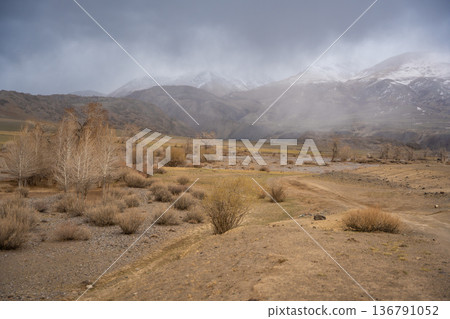 Gravel road through deserted valley leading from Mars Altai Russia. Remote pathway to famous colorful geological landmark. Gravel road through deserted valley leading from Mars Altai Russia. Remote pathway to famous colorful geological landmark. 136791052