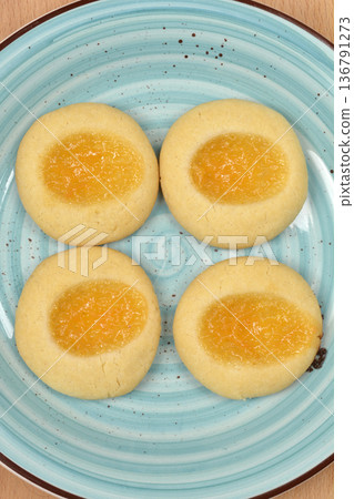 Baked lemon curd cookies on a blue ceramic plate Baked lemon curd cookies on a blue ceramic plate 136791273