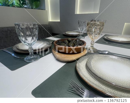 a table with a bowl of dolma with glasses a table with a bowl of dolma with glasses 136792125