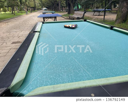 pool table with balls in a recreation park pool table with balls in a recreation park 136792149