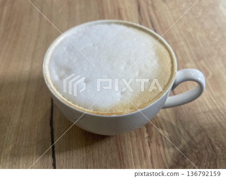 a cappuccino cup isolated on wooden table a cappuccino cup isolated on wooden table 136792159