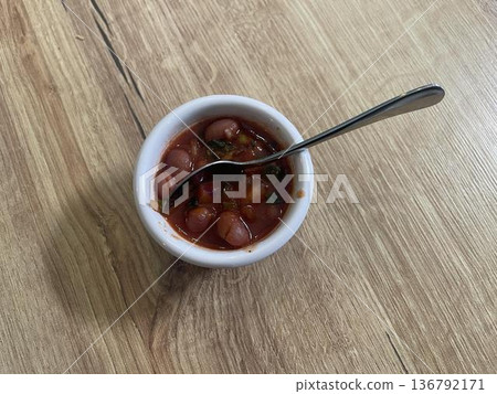bowl of beans isolated on wooden table 136792171