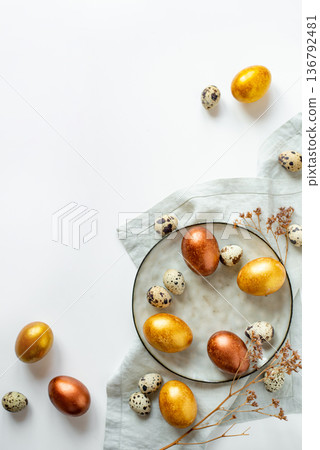 Golden and bronze Easter eggs in a grey plate Golden and bronze Easter eggs in a grey plate 136792481