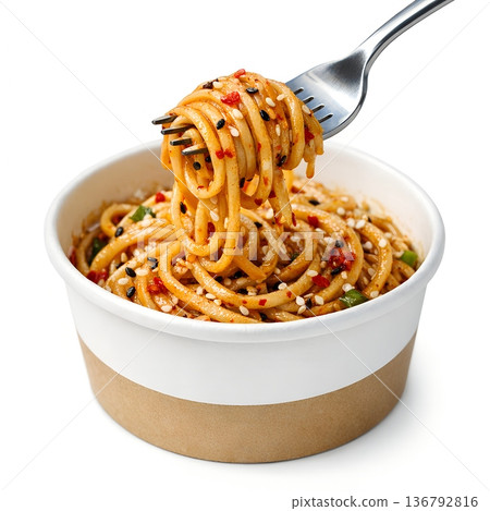 Fork lifting a tangle of spicy asian noodles with sesame seeds in a disposable paper bowl, perfect for takeout, street food, and quick meals 136792816