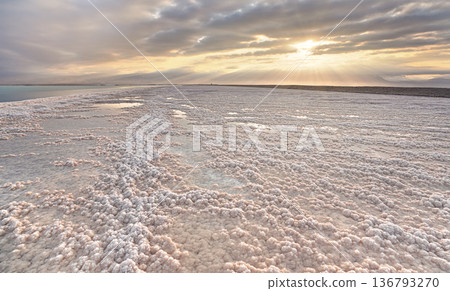 Crystalline white salt beach lit by morning sun, small puddles with seawater at Dead Sea - world most hypersaline lake 136793270