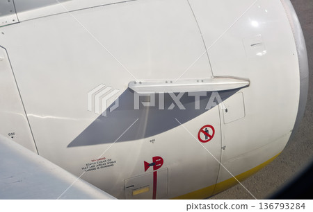 Warning and information signs on commercial airplane jet engine covering Warning and information signs on commercial airplane jet engine covering 136793284