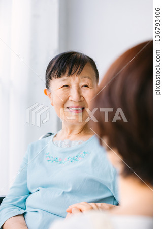 Senior women with caregivers and wheelchairs Senior women with caregivers and wheelchairs 136793406