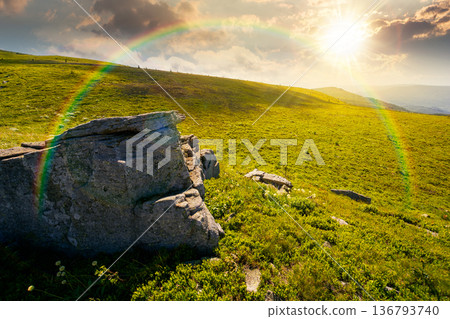 alpine mountain landscape at sunset. untouched grass and sharp sandstone on wide meadow in evening light. travel background for hiking in summer. rolling earth day wallpaper with rainbow alpine mountain landscape at sunset. untouched grass and sharp sandstone on wide meadow in evening light. travel background for hiking in summer. rolling earth day wallpaper with rainbow 136793740