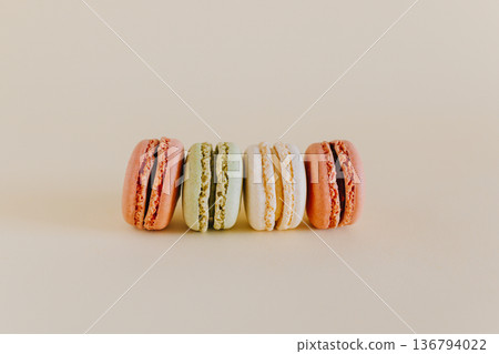 Tasty french macarons on a peach pastel background. 136794022
