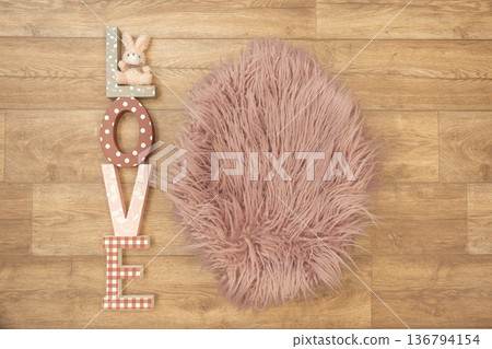 Stylish flat lay with wooden letters spelling love and fluffy pink texture. Idea of romance, celebration, tenderness and holiday decoration. Stylish flat lay with wooden letters spelling love and fluffy pink texture. Idea of romance, celebration, tenderness and holiday decoration. 136794154
