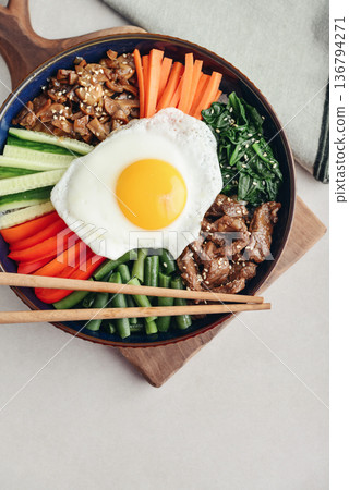 Bibimbap on a concrete background Bibimbap on a concrete background 136794271