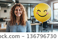 Smiling Woman Holding Balloon Creating a Healthy Office Vibe 136796730