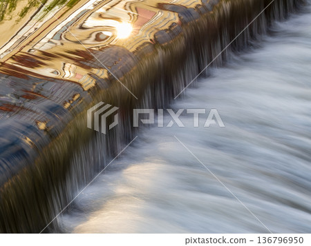 A small flat cascade in a calm river 136796950