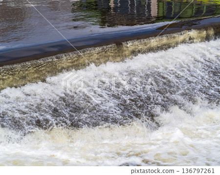 A small flat cascade in a calm river A small flat cascade in a calm river 136797261