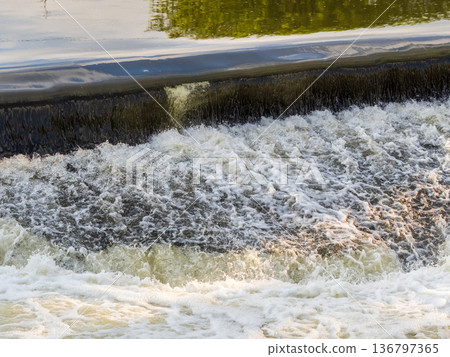 A small flat cascade in a calm river A small flat cascade in a calm river 136797365