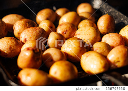 Golden roasted potatoes cooking in a warm kitchen on a cozy autumn evening 136797638
